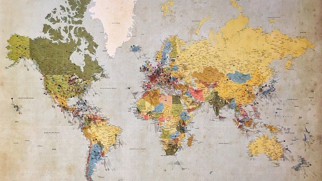 Vintage world map with location pins marking cities globally (photo: Andrew Stutesman via Unsplash)